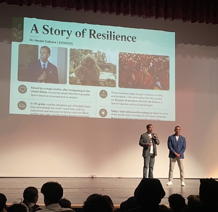 A speaker sharing their story of resilience on stage at an EVOKicks event