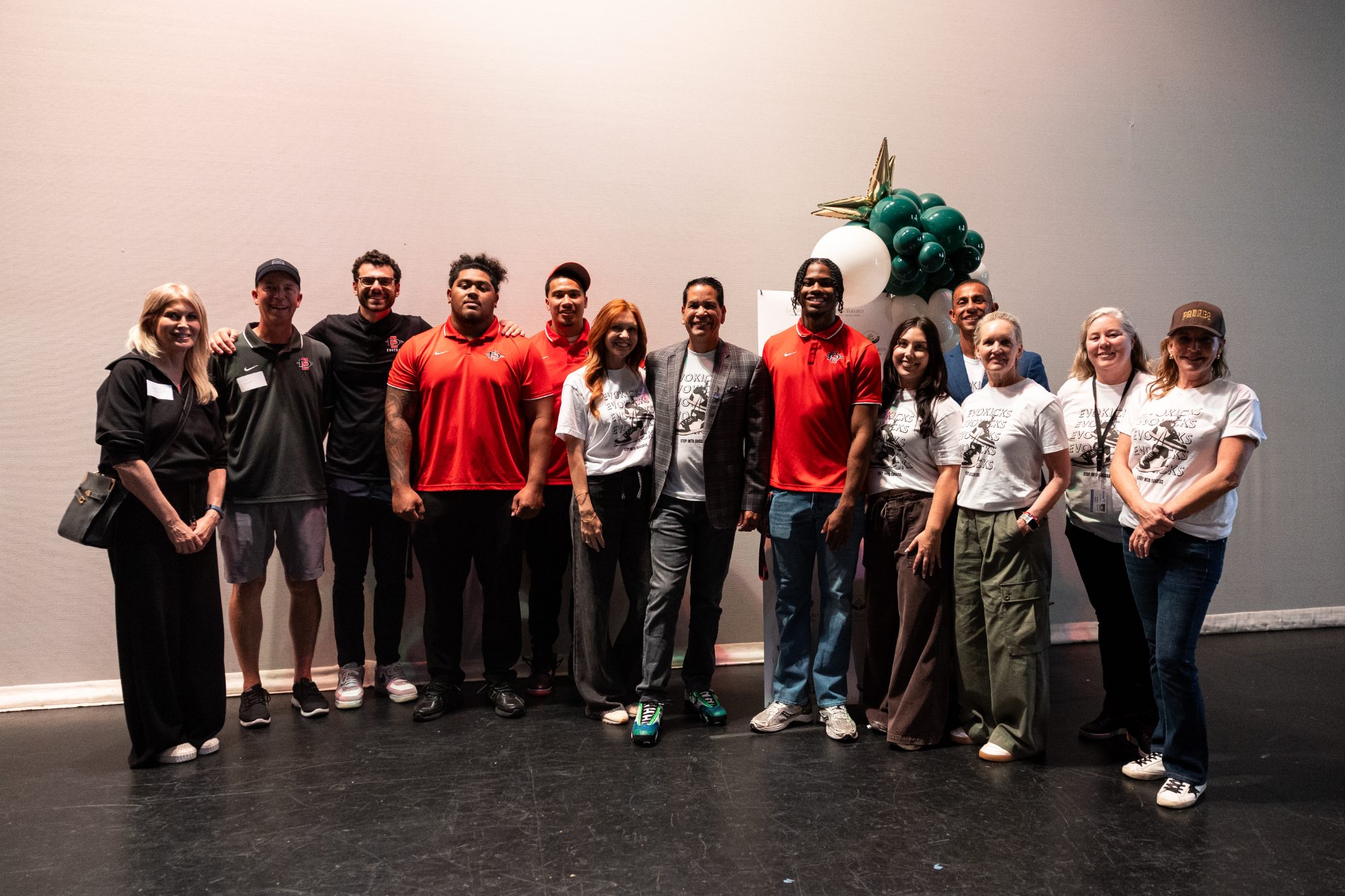 EVOKicks event group photo with volunteers, athletes, and partners